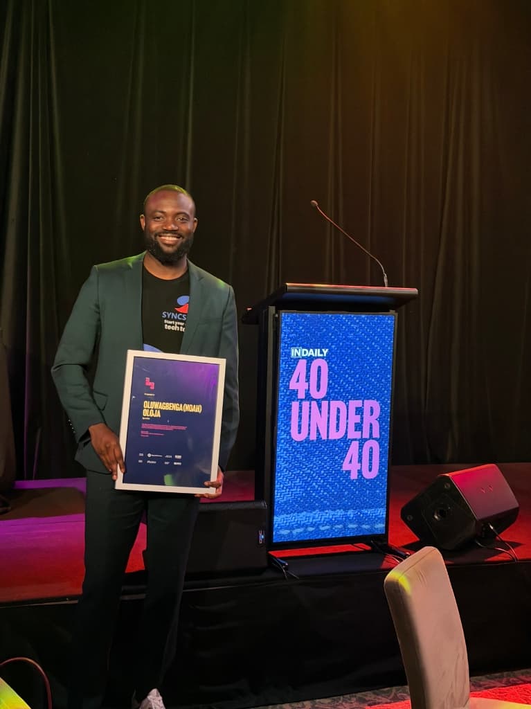 Noah receiving 40 Under 40 Business Leader Award on stage